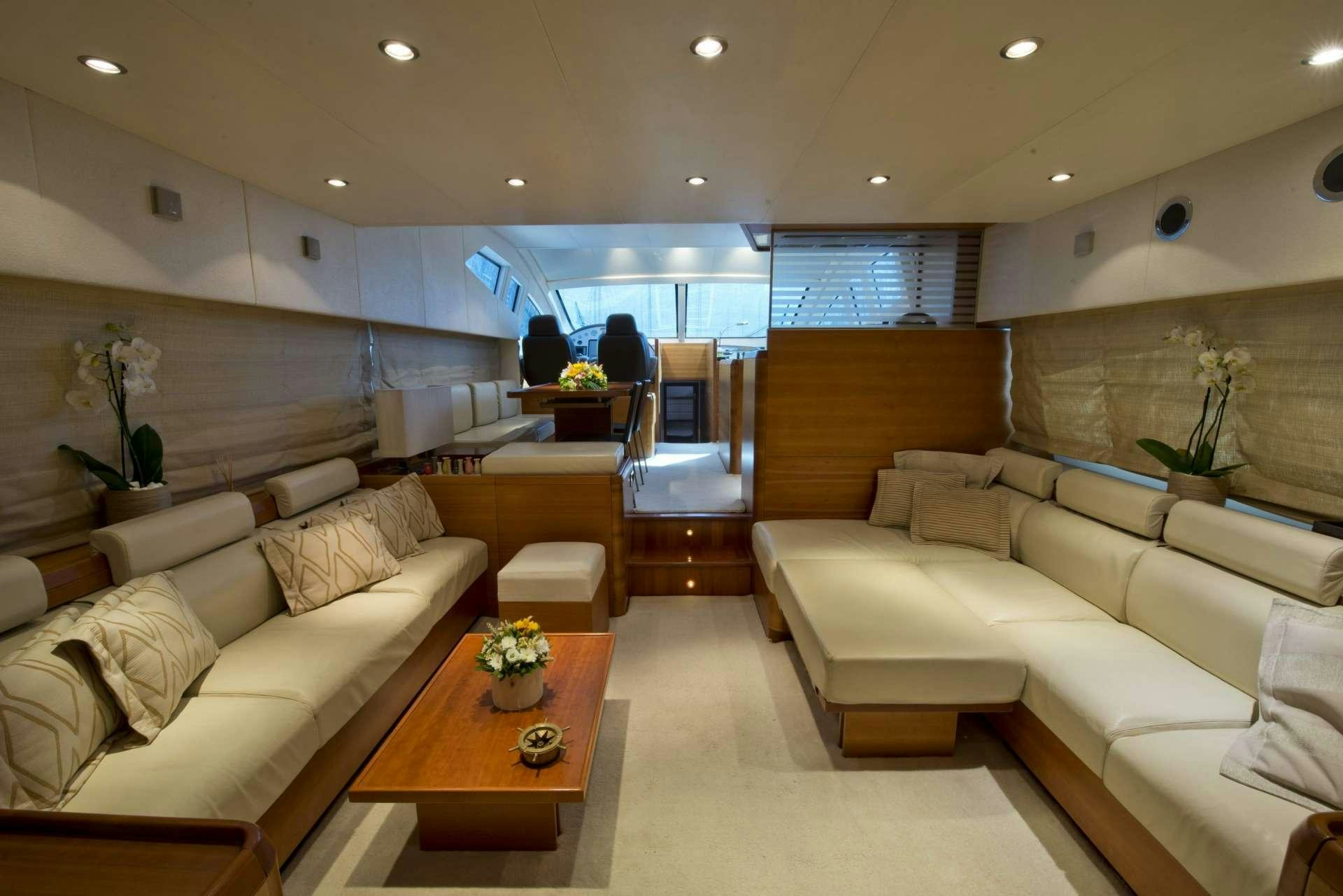 a living room with a couch and a coffee table aboard JULY Yacht for Charter