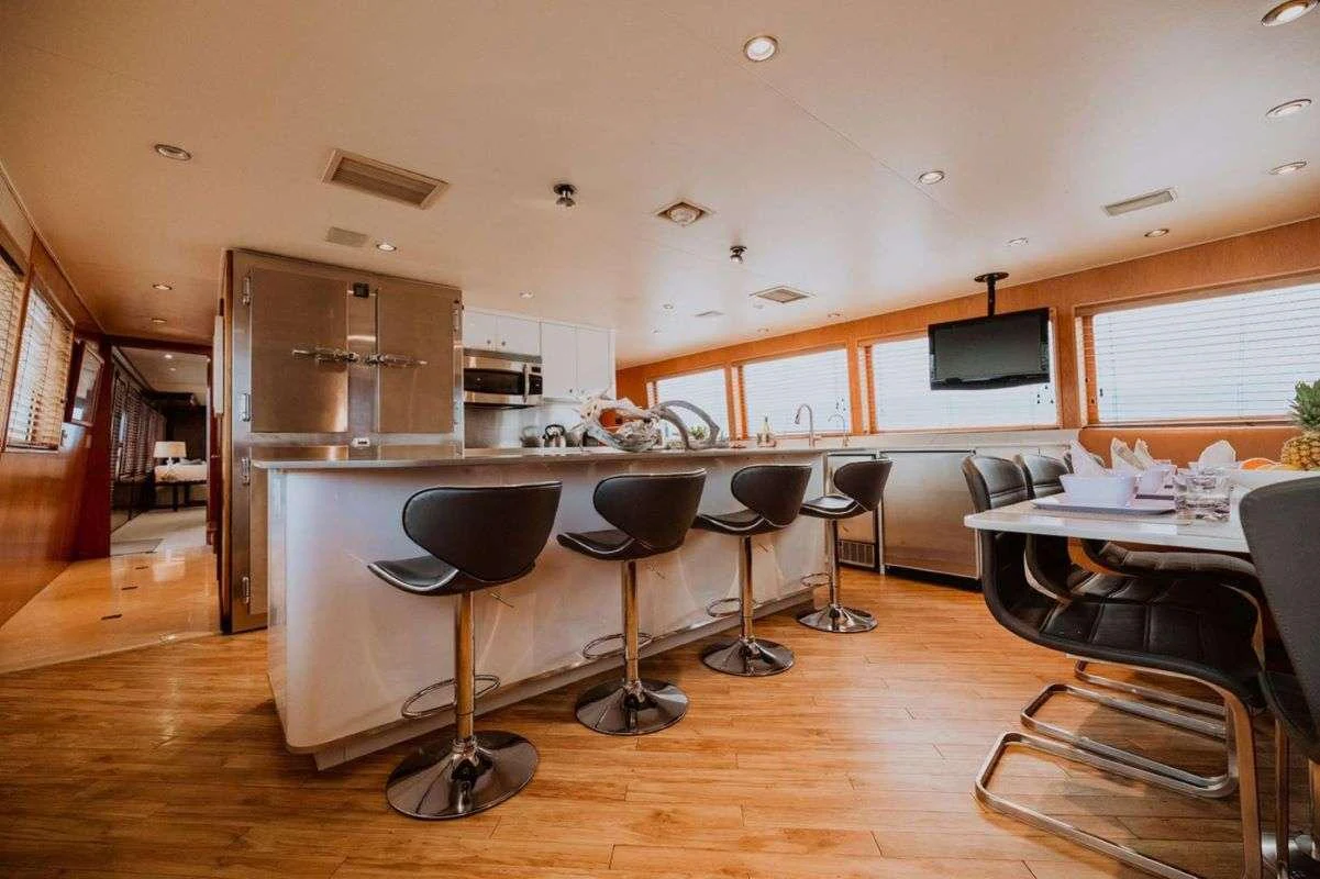 The yacht's galley features a spacious layout with modern appliances and ample seating. aboard SKY Yacht for Charter