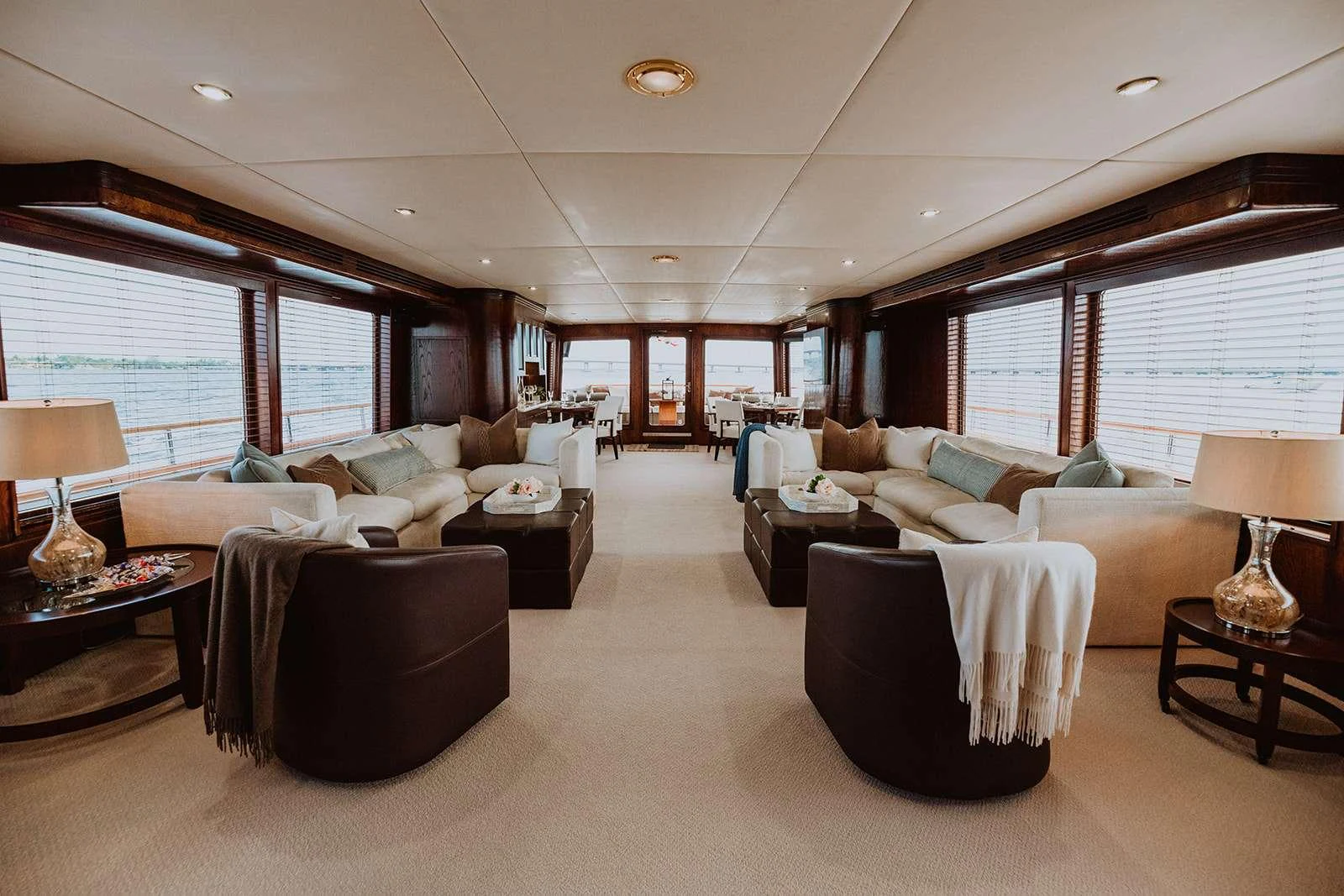 The spacious salon features elegant seating areas with ample natural light from large windows. aboard SKY Yacht for Charter