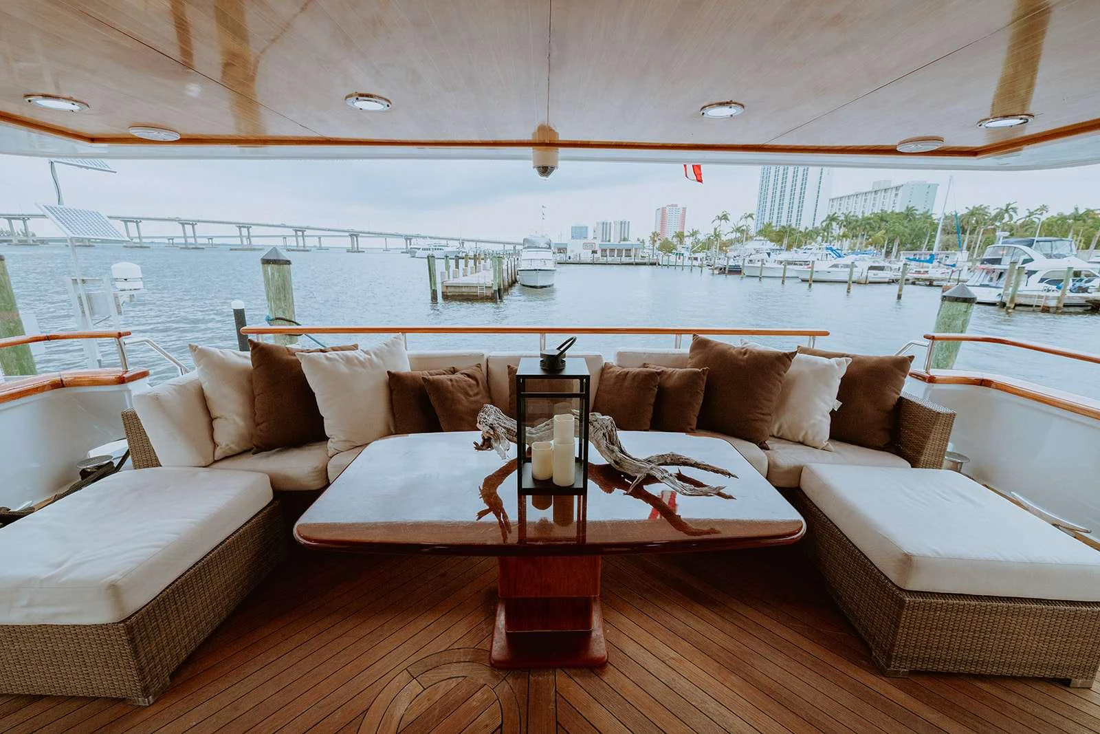 The aft deck offers a cozy seating area with plush cushions and a central table, perfect for relaxing and enjoying the view. aboard SKY Yacht for Charter
