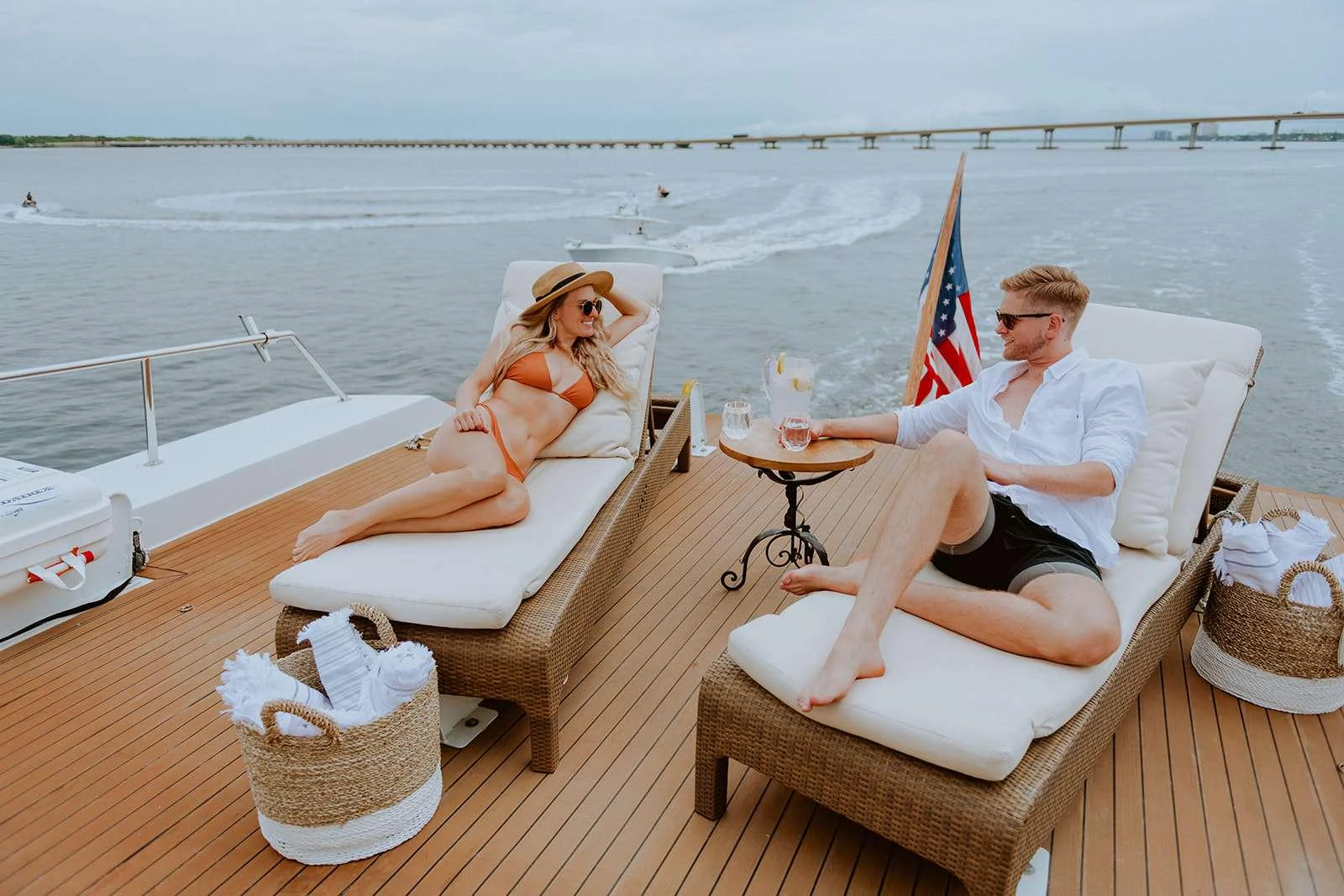 The aft deck offers a relaxing space with sun loungers and a small table, perfect for enjoying the view and a drink. aboard SKY Yacht for Charter