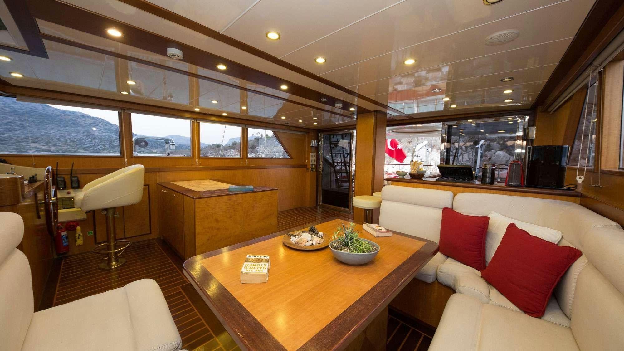 a room with a table and chairs aboard SERENITY 86 Yacht for Charter