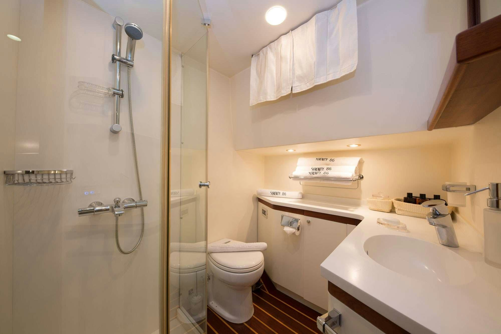 a bathroom with a glass shower aboard SERENITY 86 Yacht for Charter