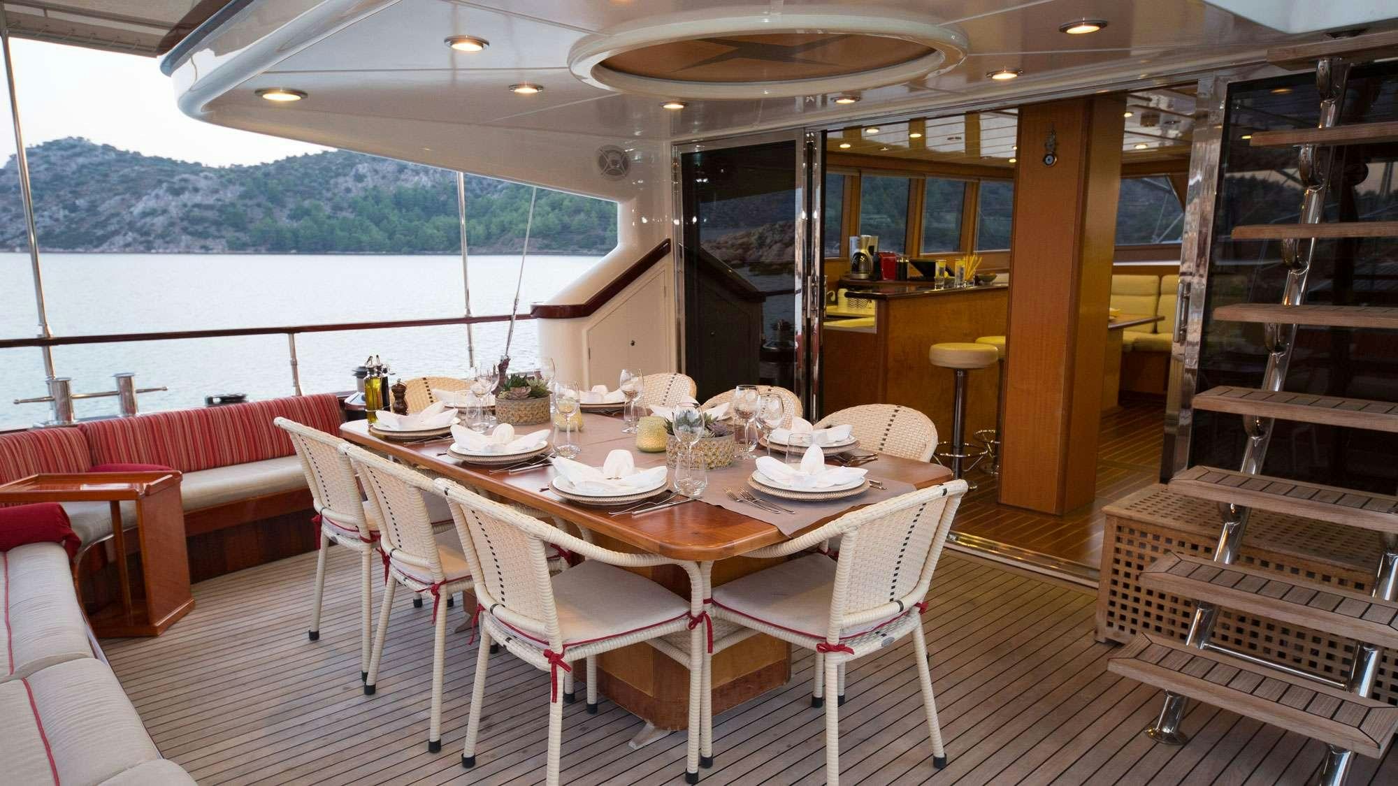 a dining room with a table and chairs aboard SERENITY 86 Yacht for Charter