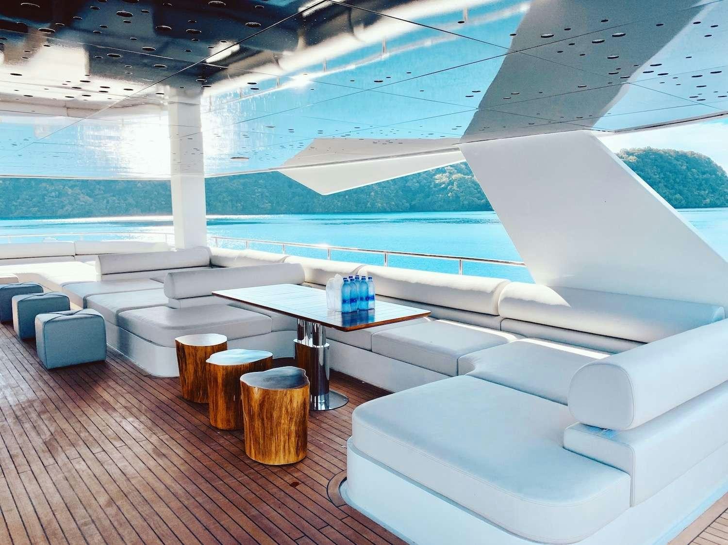 a room with a table and chairs aboard BLACK PEARL I Yacht for Charter
