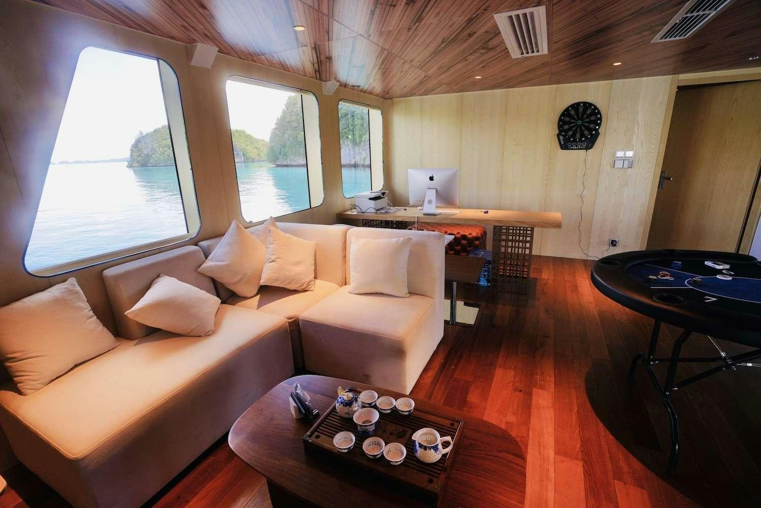 a living room with a couch and a table aboard BLACK PEARL I Yacht for Charter