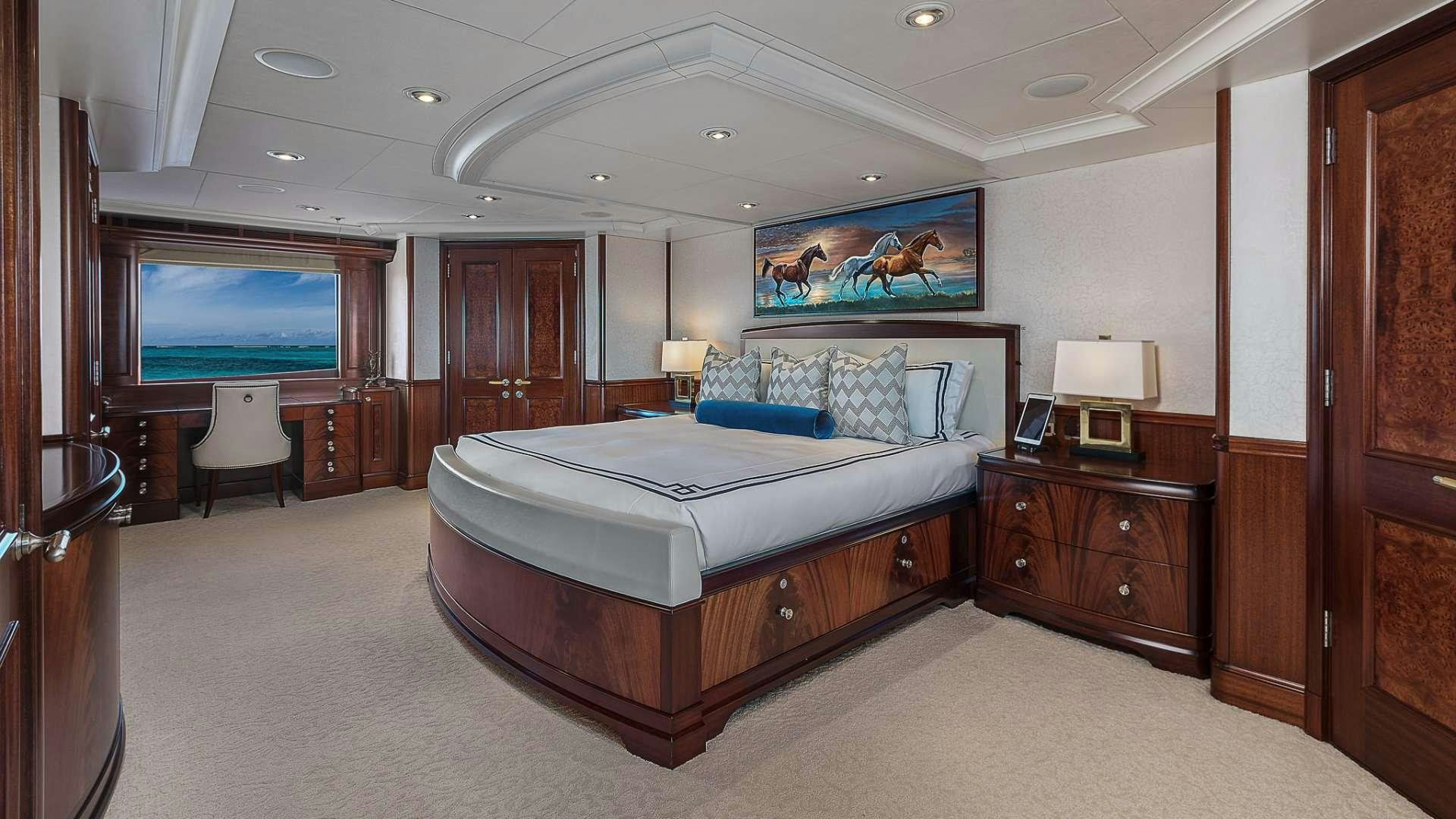 a bedroom with a bed and a television aboard AVALON Yacht for Charter