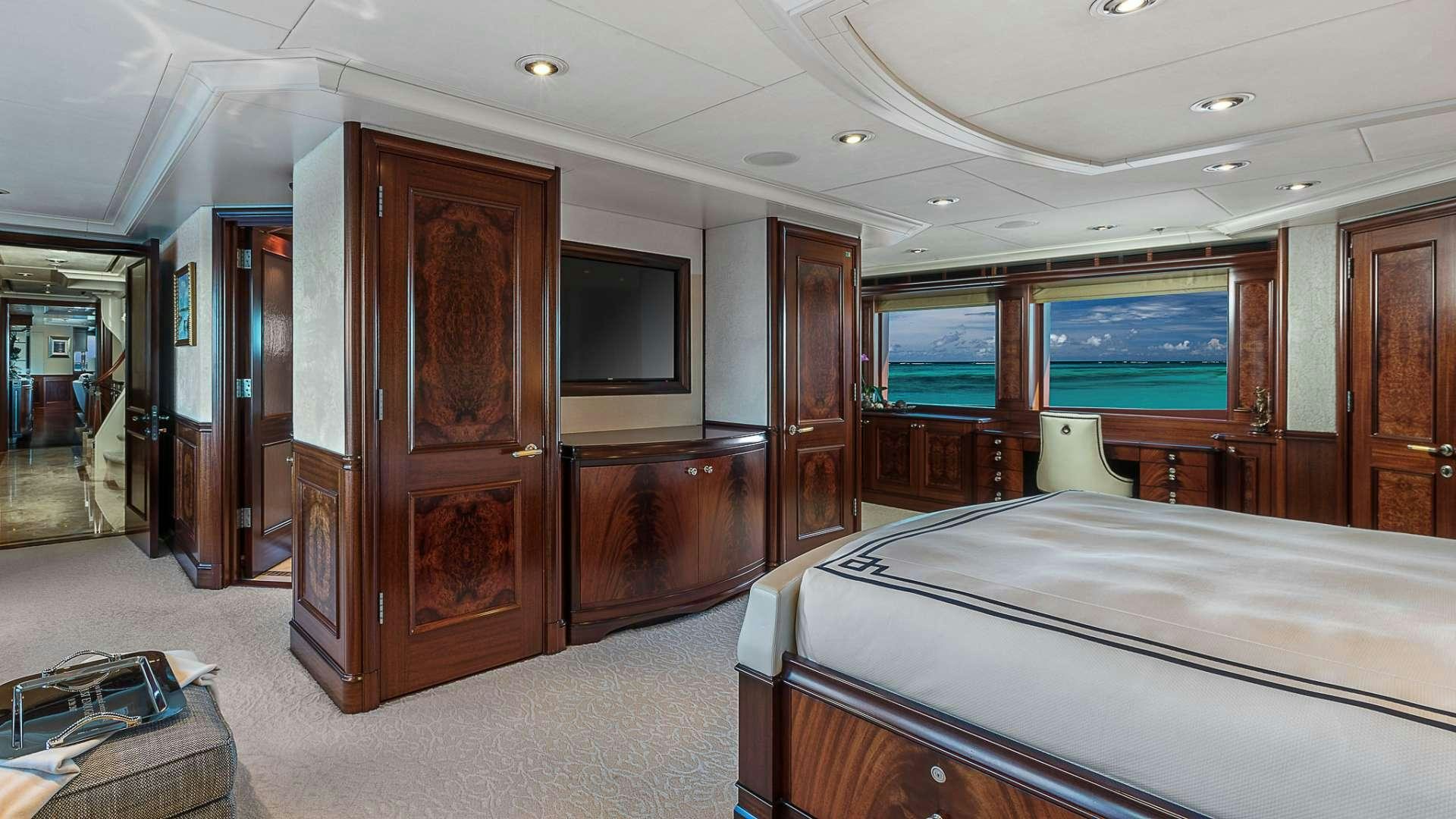 a room with a bed and a television aboard AVALON Yacht for Charter