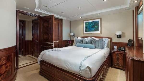 a bedroom with a bed and a desk aboard AVALON Yacht for Charter