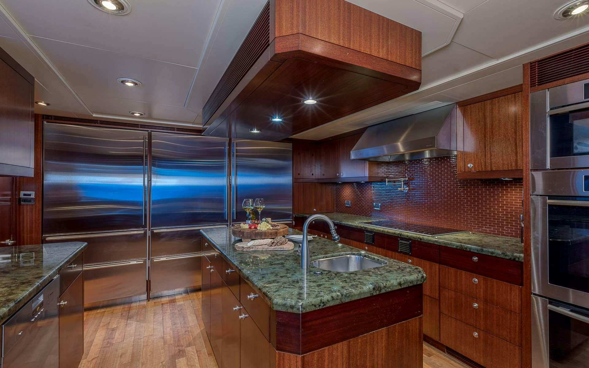 a kitchen with a large island aboard AVALON Yacht for Charter