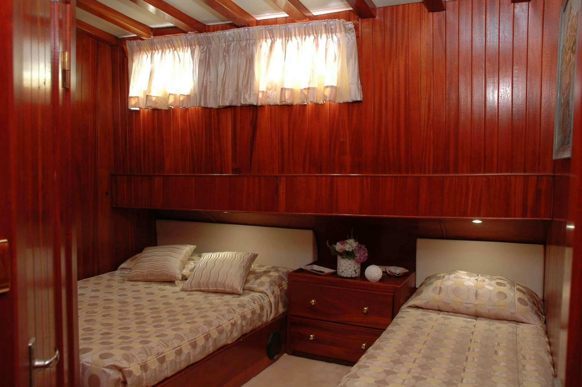 a couple of beds in a room aboard MATINA Yacht for Charter