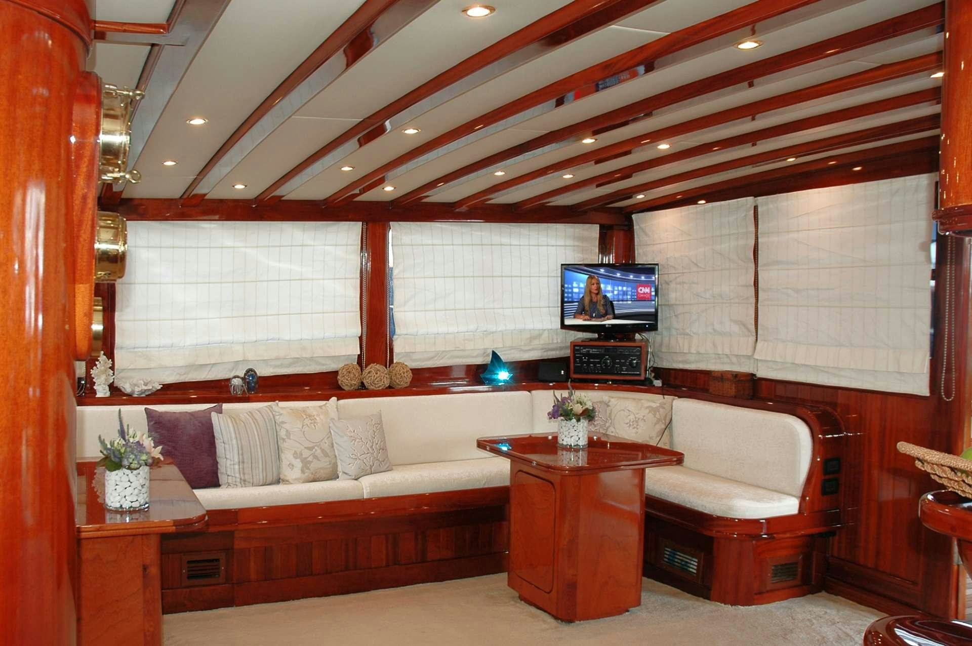 a living room with a couch and a tv aboard MATINA Yacht for Charter