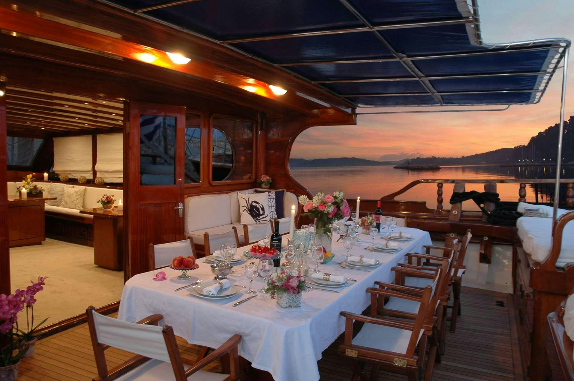 a table set for a dinner party aboard MATINA Yacht for Charter