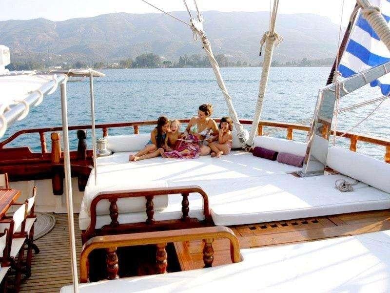 a group of people sitting on a boat aboard MATINA Yacht for Charter