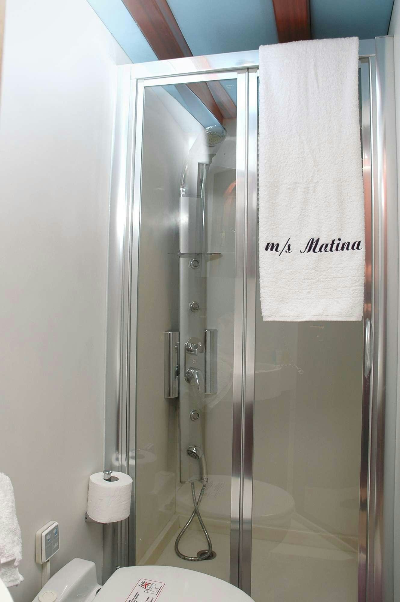 a shower with a glass door aboard MATINA Yacht for Charter