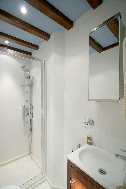 a bathroom with a shower and sink aboard MATINA Yacht for Charter
