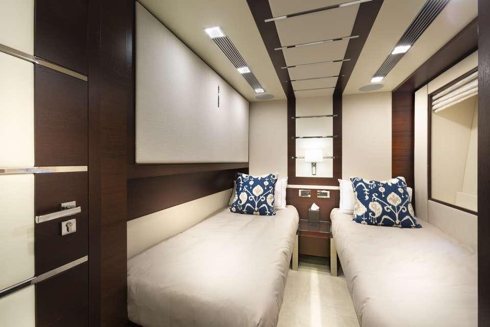 a room with a bed and a desk aboard INSIEME Yacht for Charter