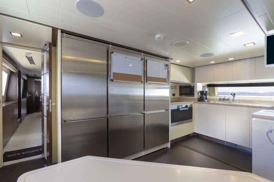 a large kitchen with stainless steel appliances aboard INSIEME Yacht for Charter