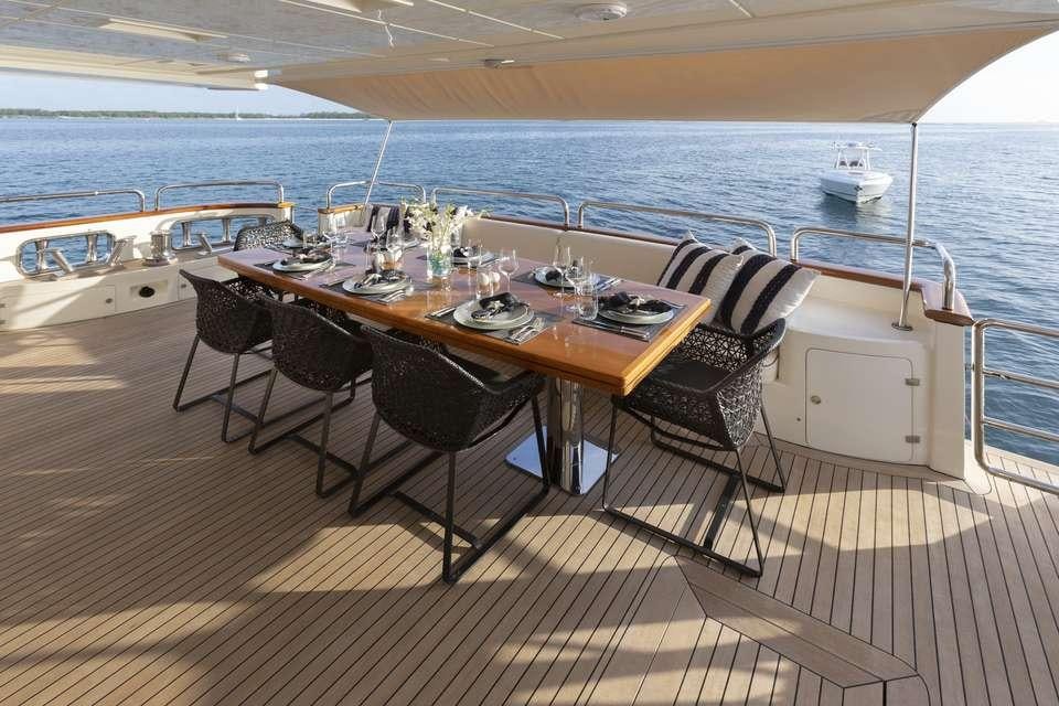 a dining table on a deck aboard INSIEME Yacht for Charter