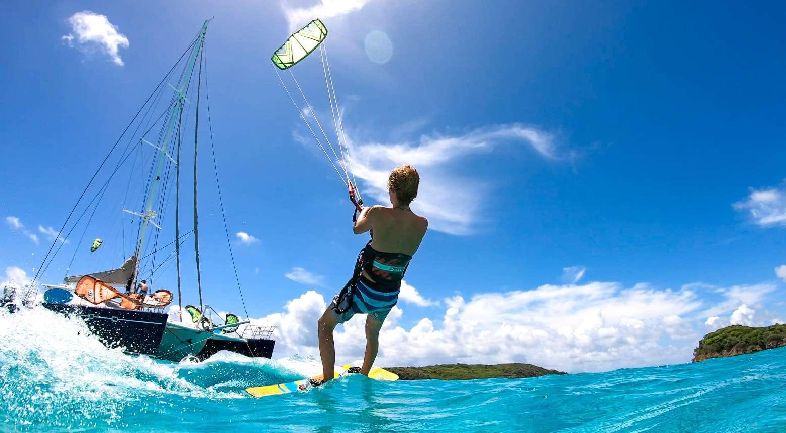 a man is parasailing on a surfboard aboard FELICIA Yacht for Charter