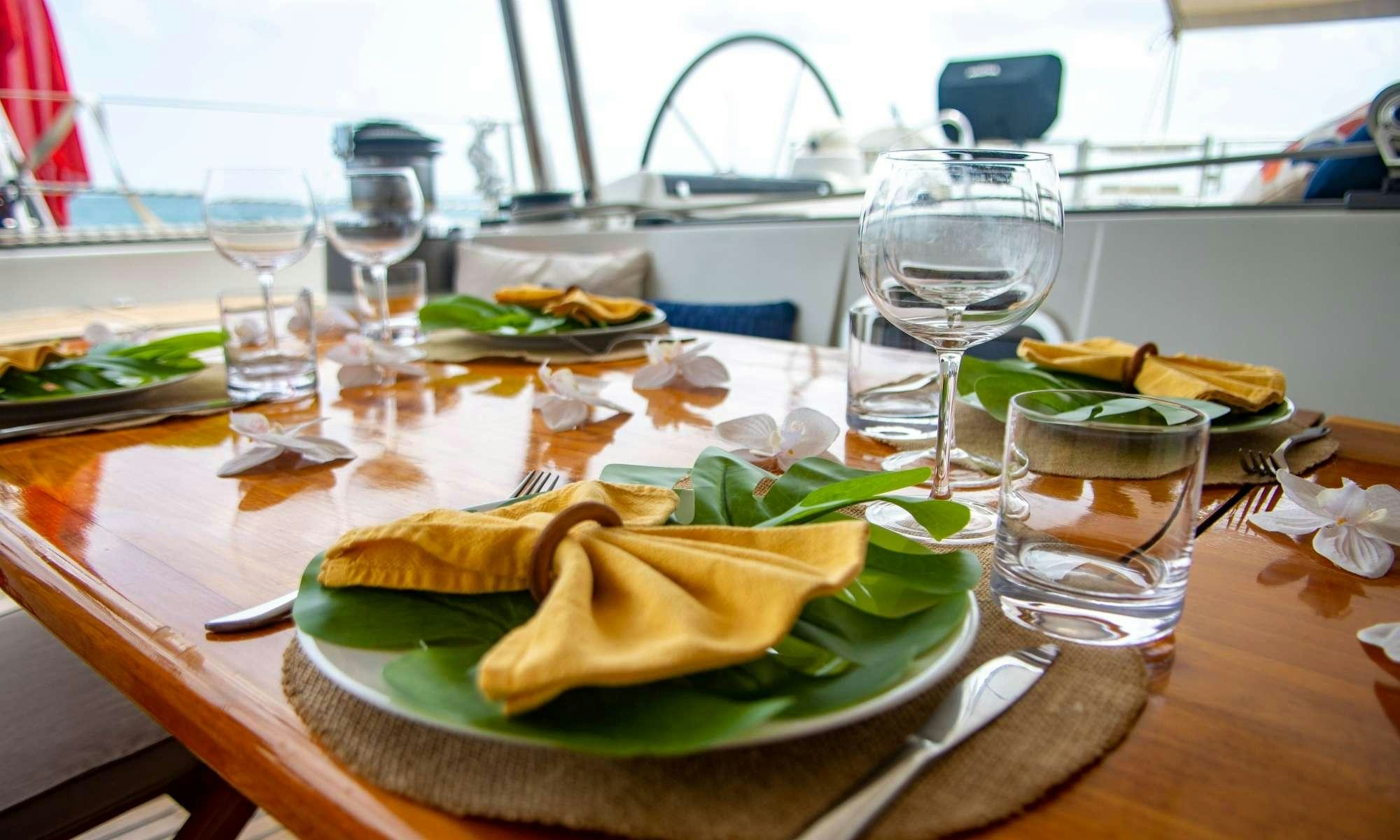 a table with food and glasses aboard FELICIA Yacht for Charter