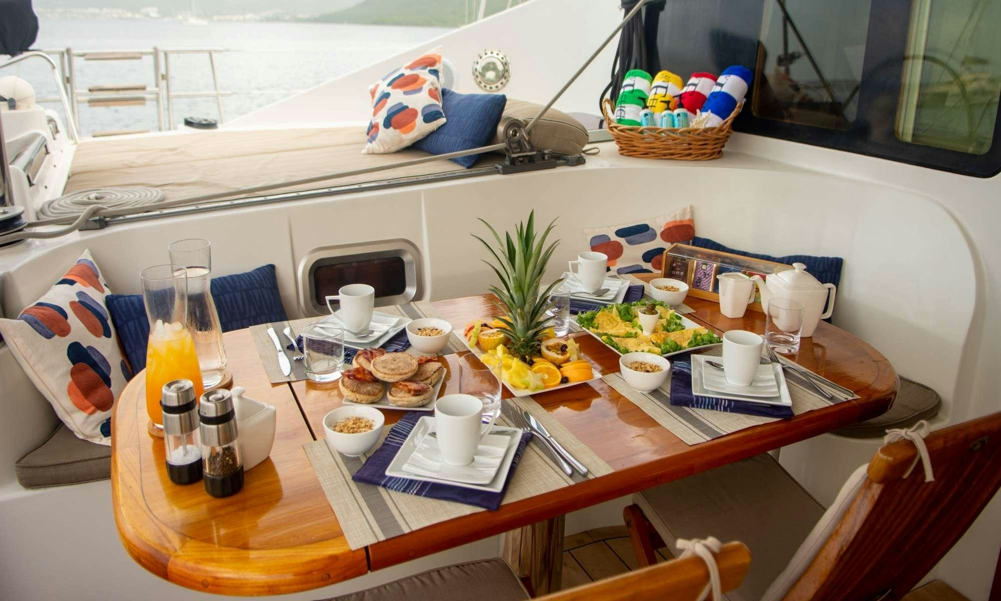 a table with food and drinks on it aboard FELICIA Yacht for Charter