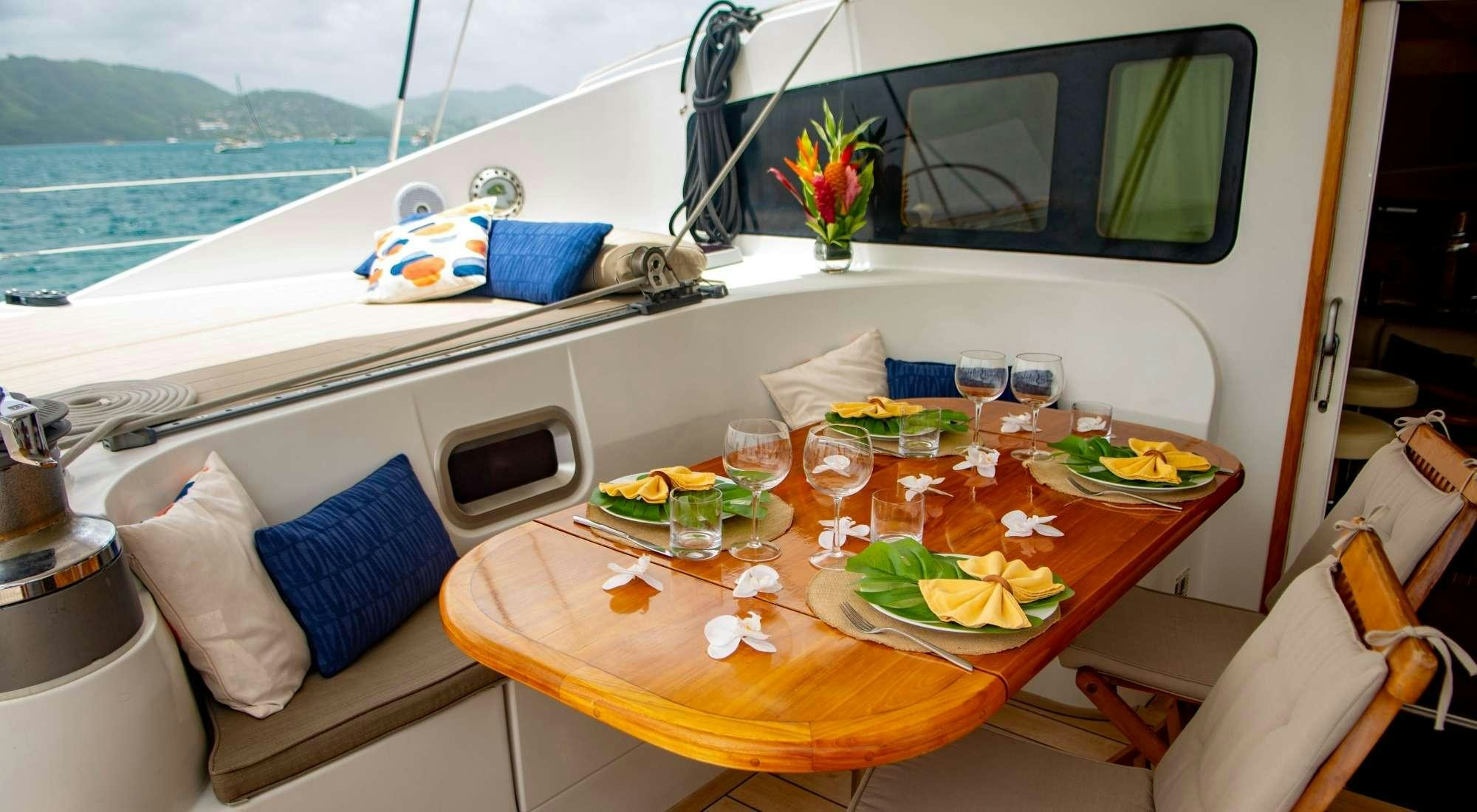 a table with food and drinks on it aboard FELICIA Yacht for Charter