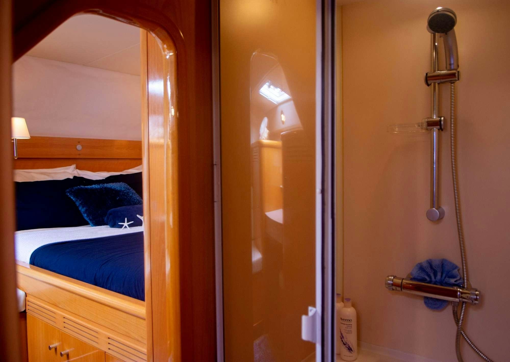 a bathroom with a glass shower aboard FELICIA Yacht for Charter