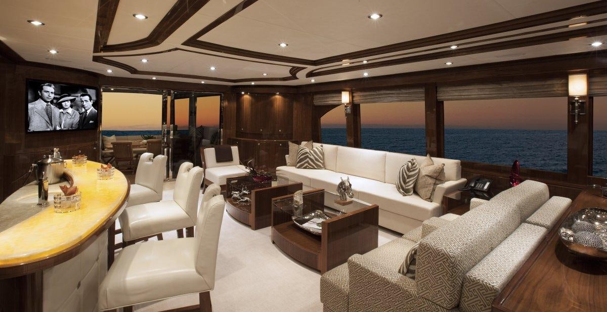 a living room with a large television aboard CARBON COPY Yacht for Charter