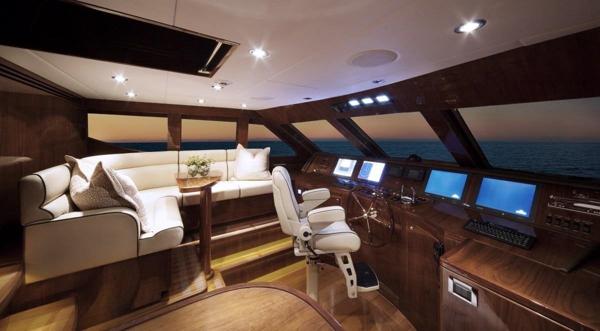 a room with a couch and a desk with a computer aboard CARBON COPY Yacht for Charter