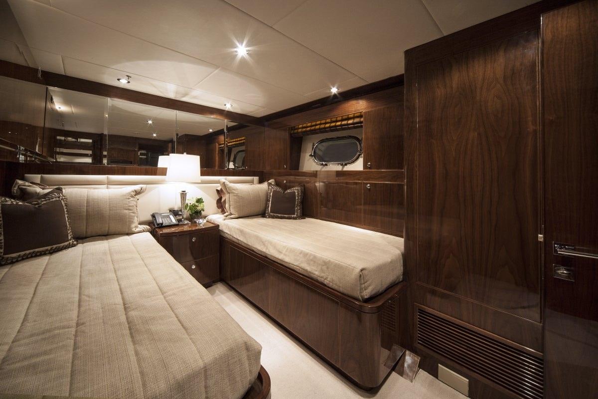 a room with a bed and a mirror aboard CARBON COPY Yacht for Charter