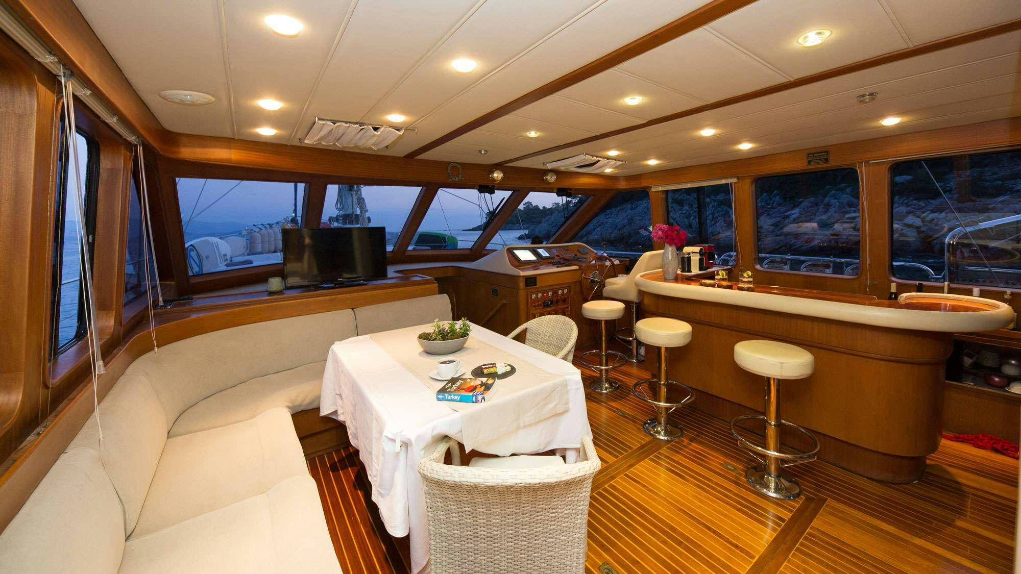 a room with a table and chairs aboard SERENITY 70 Yacht for Charter
