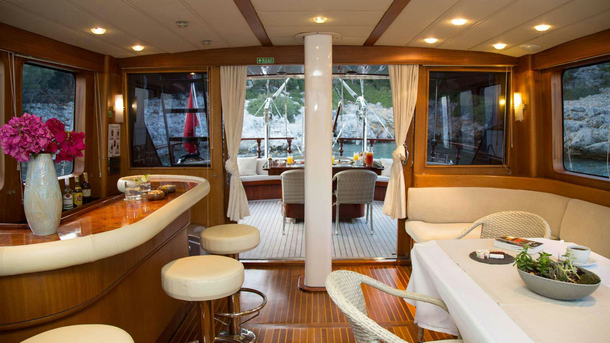 a room with a table and chairs aboard SERENITY 70 Yacht for Charter