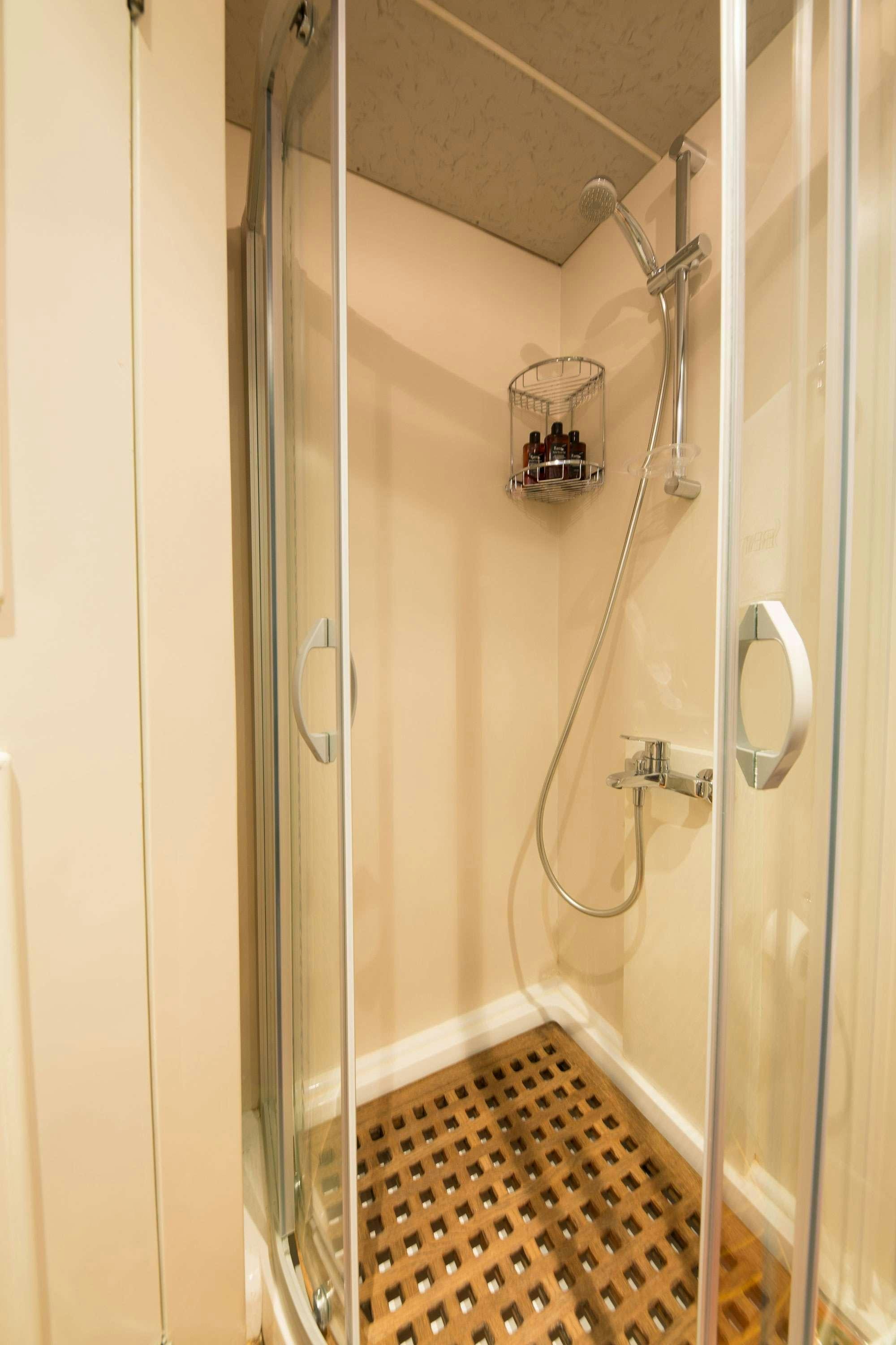 a shower with a tile floor aboard SERENITY 70 Yacht for Charter