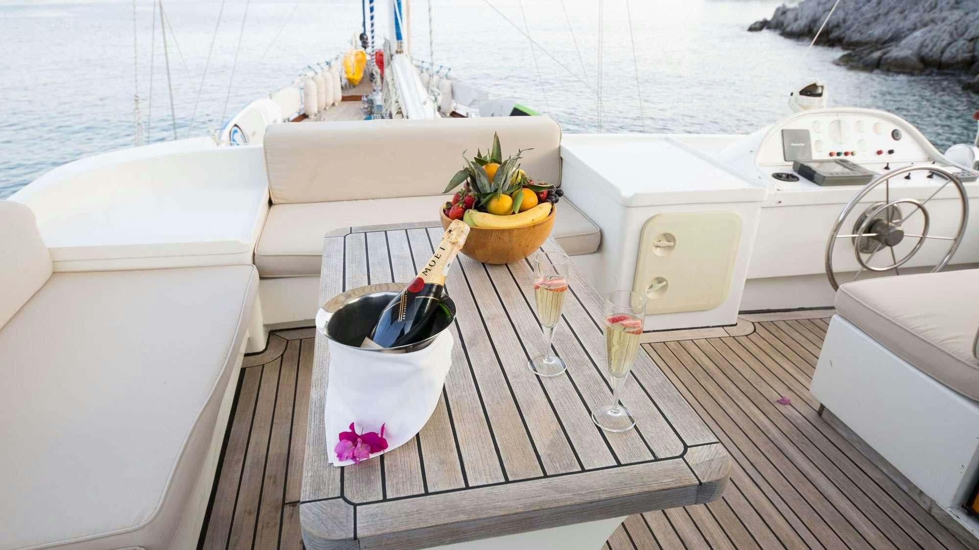 a boat with a basket of flowers on the deck aboard SERENITY 70 Yacht for Charter