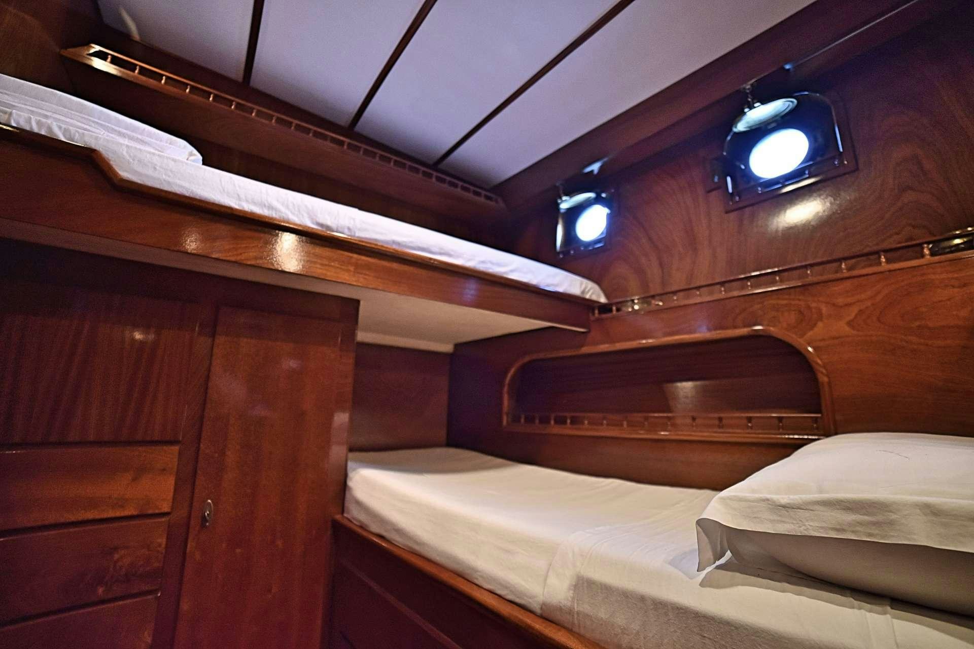a room with a bed and a nightlight aboard ENTRANCER Yacht for Charter