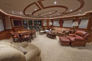 a living room with a large chandelier aboard ALICIA Yacht for Charter