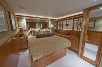 a bedroom with a bed and a mirror aboard ALICIA Yacht for Charter