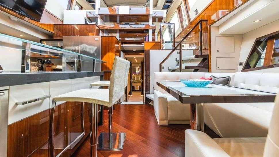 a room with a table and chairs aboard HELIOS Yacht for Charter