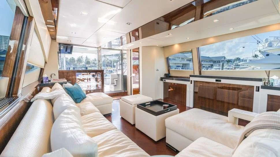 a living room with white couches aboard HELIOS Yacht for Charter