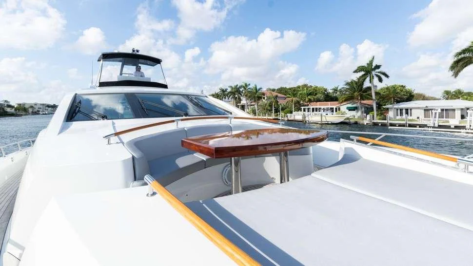 a white car on a road aboard HELIOS Yacht for Charter