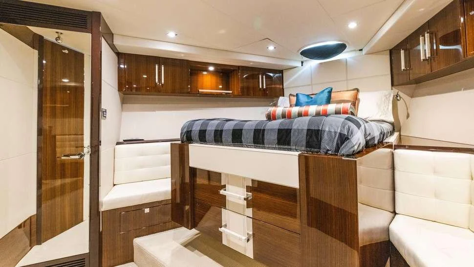 a room with a bed and a desk aboard HELIOS Yacht for Charter