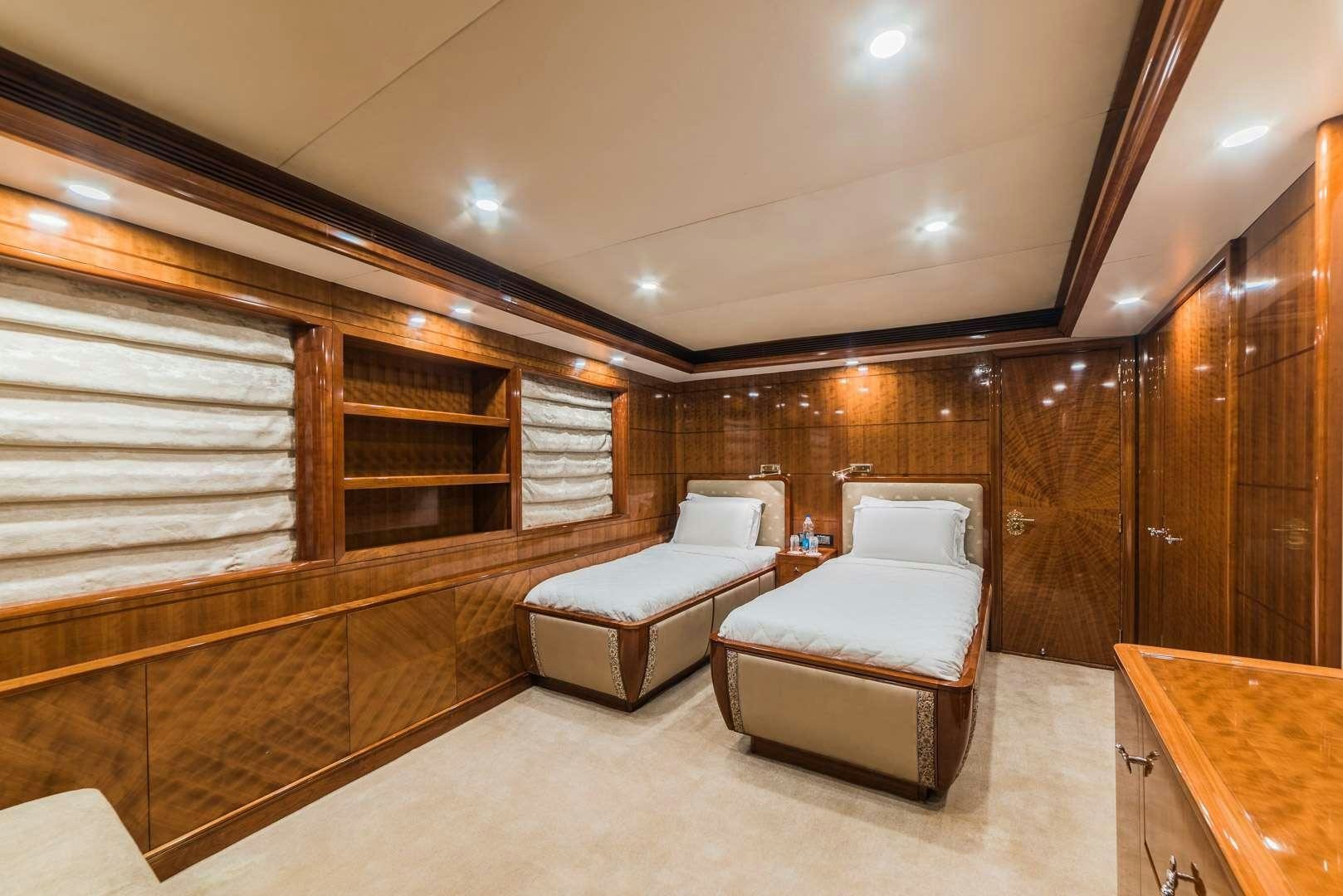 a room with a bed and a chair aboard ASHENA Yacht for Charter