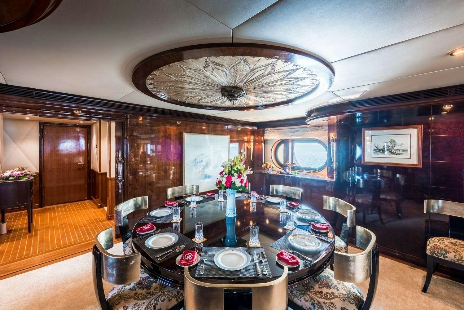 a large room with a table and chairs aboard ASHENA Yacht for Charter
