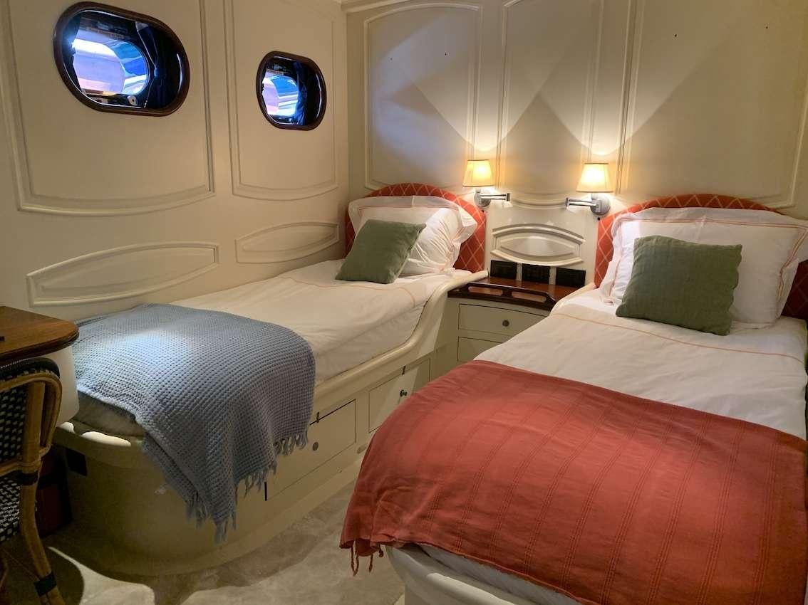 a couple of beds in a room aboard VOYAGE Yacht for Charter