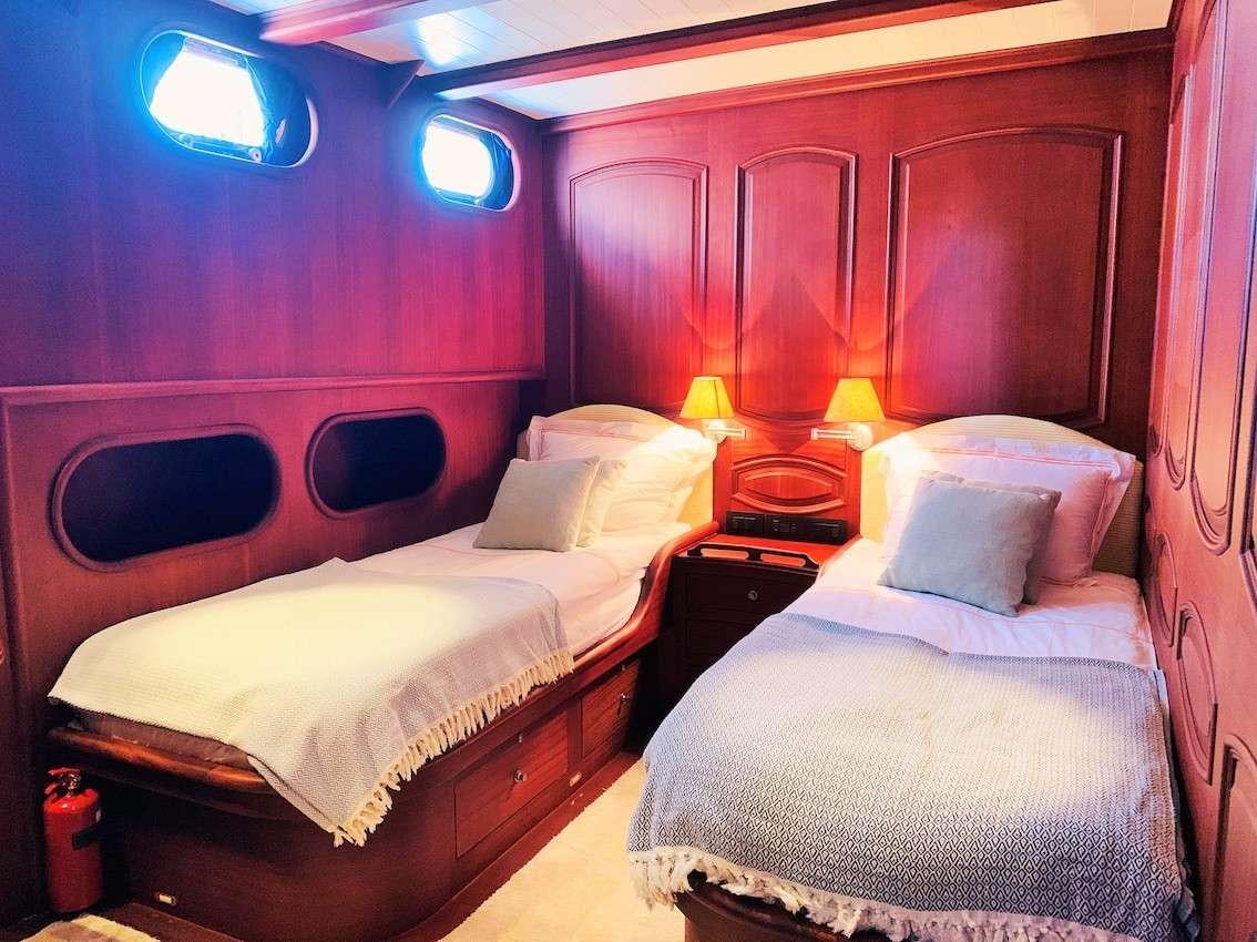 a room with two beds aboard VOYAGE Yacht for Charter