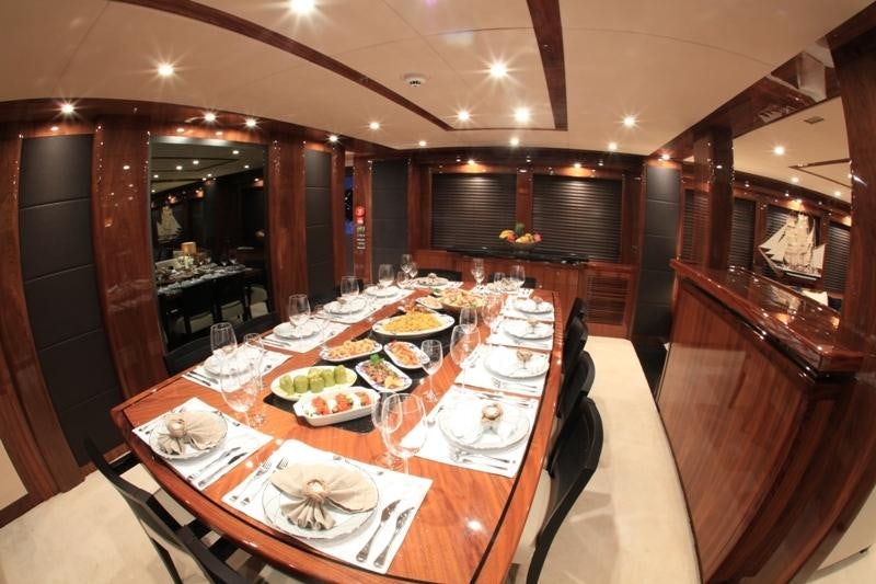 a large dining room with a large table set for a meal aboard BARACUDA Yacht for Charter