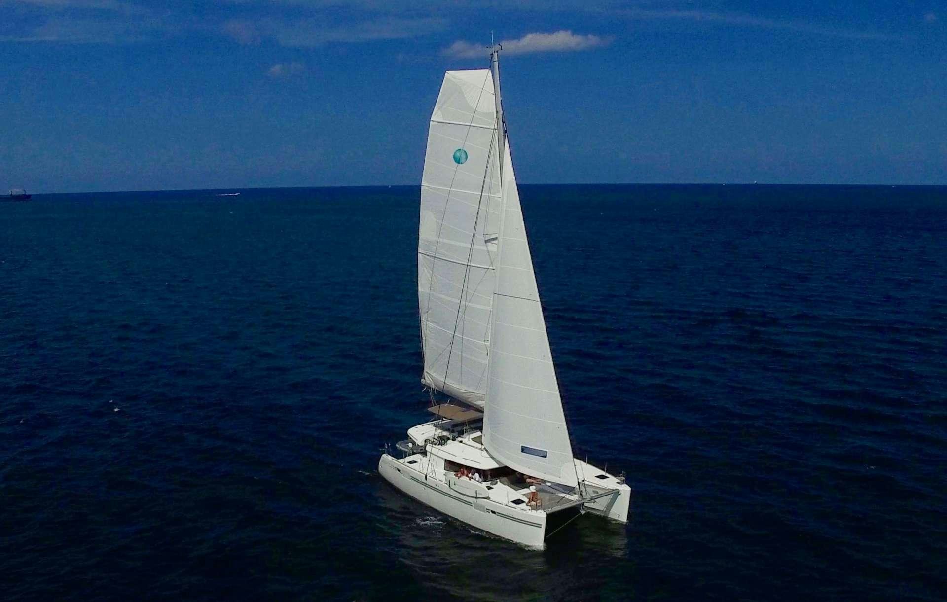 a white sailboat in the water aboard SAMORU Yacht for Charter