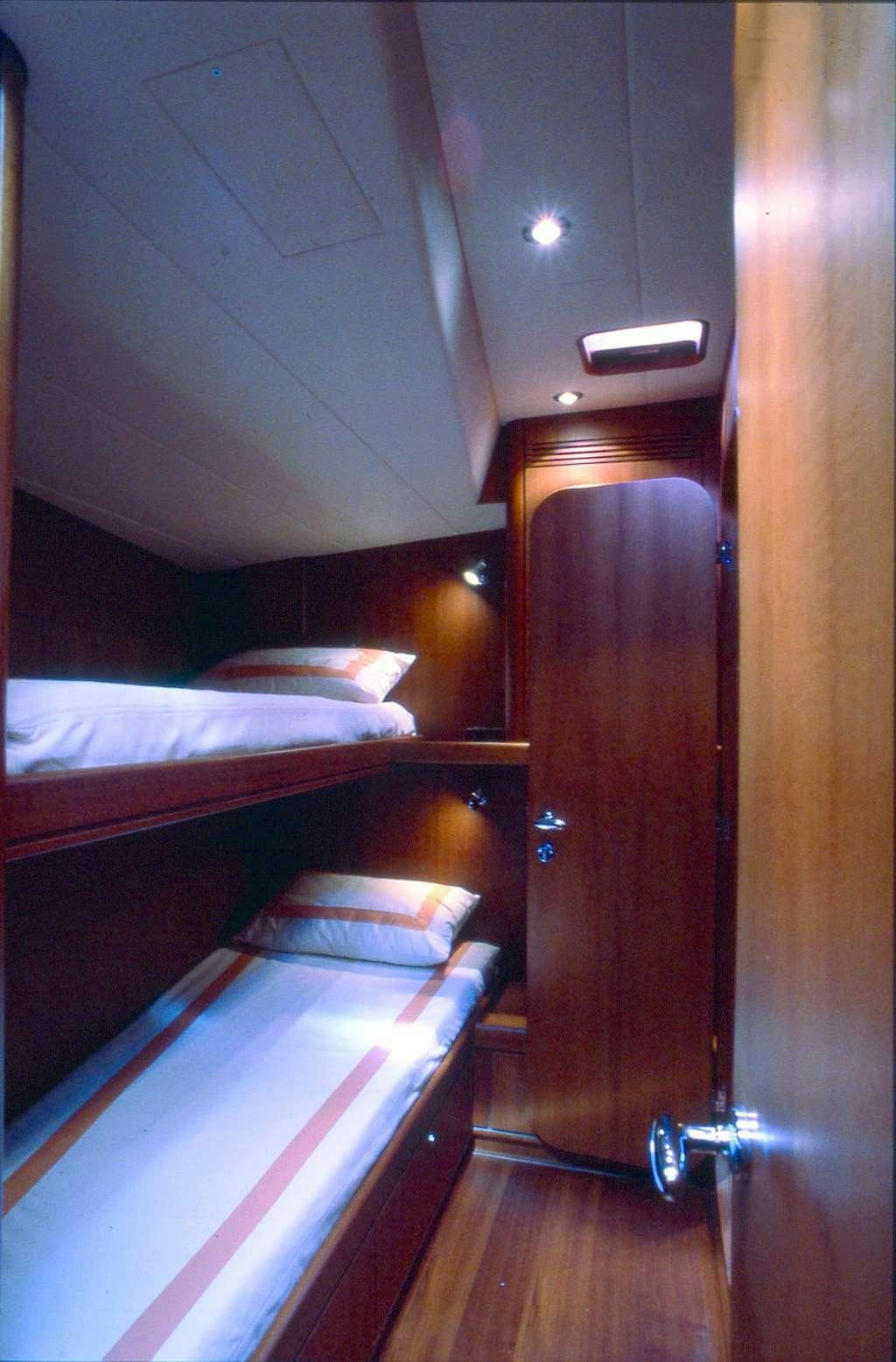 a room with bunk beds aboard CLASS IV Yacht for Charter