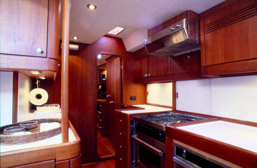 a kitchen with wooden cabinets aboard CLASS IV Yacht for Charter